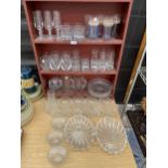 AN ASSORTMENT OF GLASS WARE TO INCLUDE FLUTES, TRIFLES BOWLS AND TUMBLERS ETC