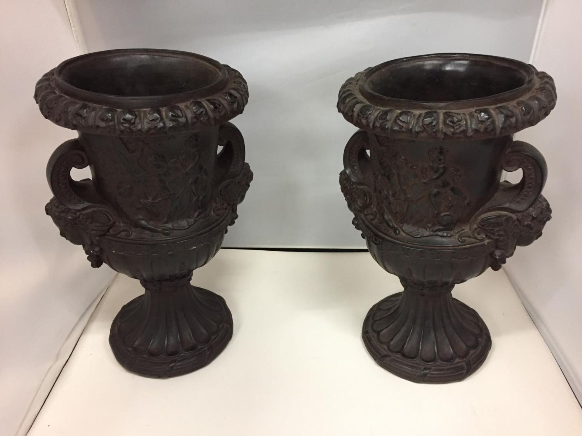 TWO DECORATIVE TWIN HANDLED RESINS URNS