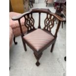 A GEORGIAN STYLE CORNER CHAIR WITH TURNED UPRIGHTS, FRETWORK BACK AND FRONT CABRIOLE LEG, ON BALL