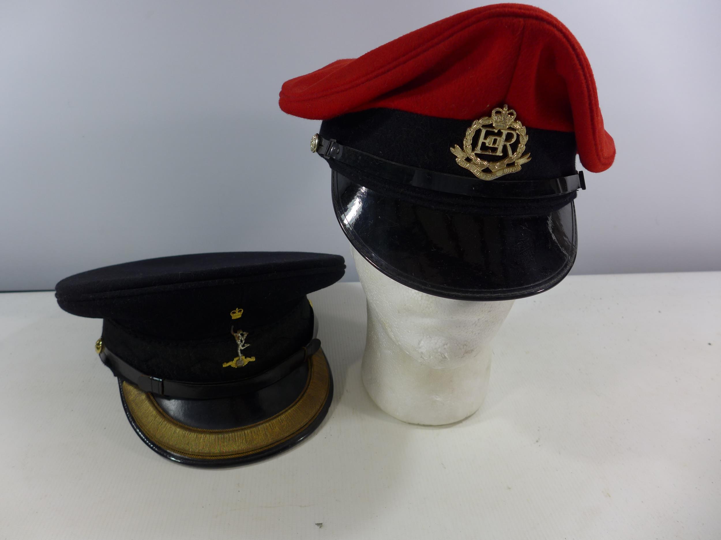 A BRITISH ROYAL MILITARY POLICE PEAKED CAP AND A ROYAL CORP OF SIGNALS PEAKED CAP, SIZE 7 1/4