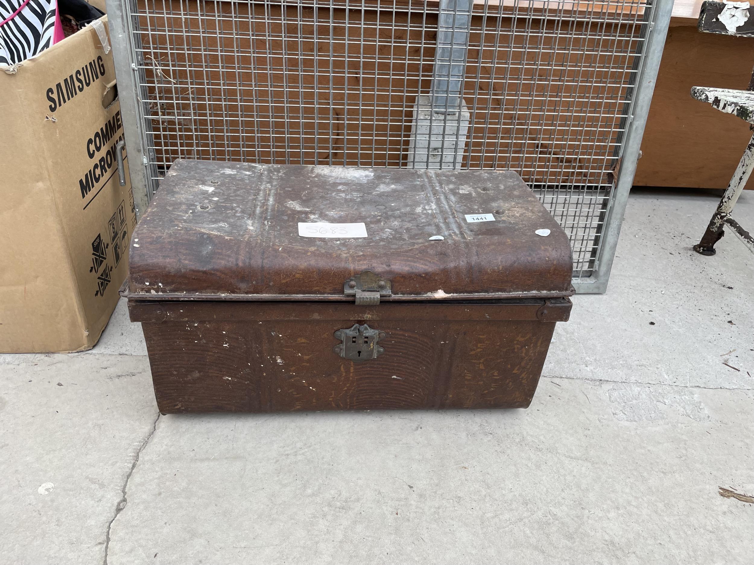 A VINTAGE TIN STORAGE TRUNK