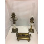 TWO BRASS OIL LAMPS WITH GLASS FUNNELS AND A BRASS DESK TIDY