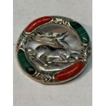 A MARKED SILVER BROOCH WITH RED AND GREEN STONES SURROUNDING A CENTRAL STAG DESIGN