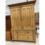 A VICTORIAN PINE HOUSEKEEPER CUPBOARD HAVING PANNELED DOORS TO THE UPPER SECTION AND TWO DRAWERS