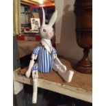 A WOODEN PAINTED SHELF PUPPET OF A RABBIT