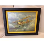 A FRAMED COLOURED CANVAS PRINT OF A BIPLANE