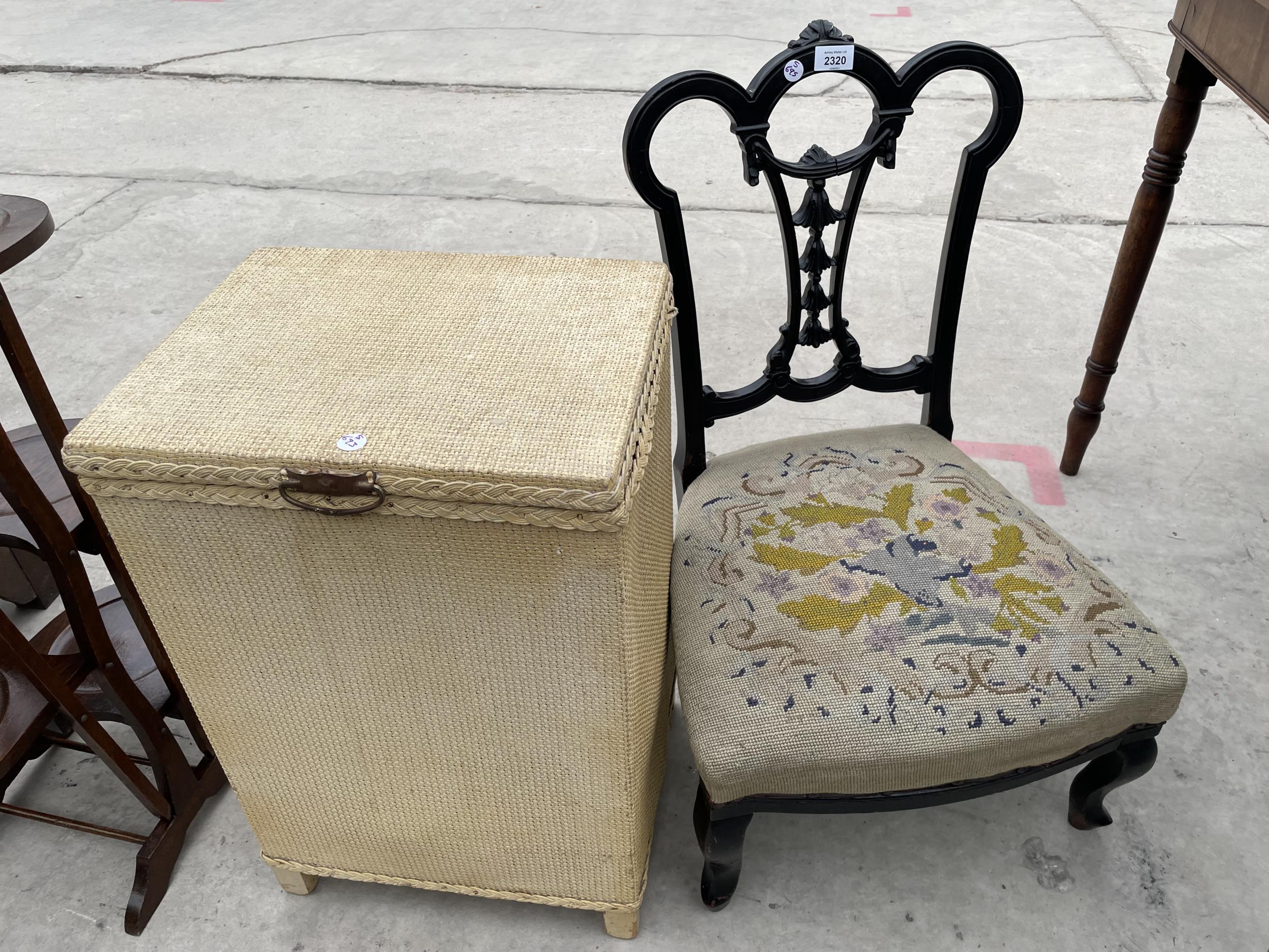 AN EBONISED NURSING CHAIR AND LLOYD LOOM STYLE OTTOMAN