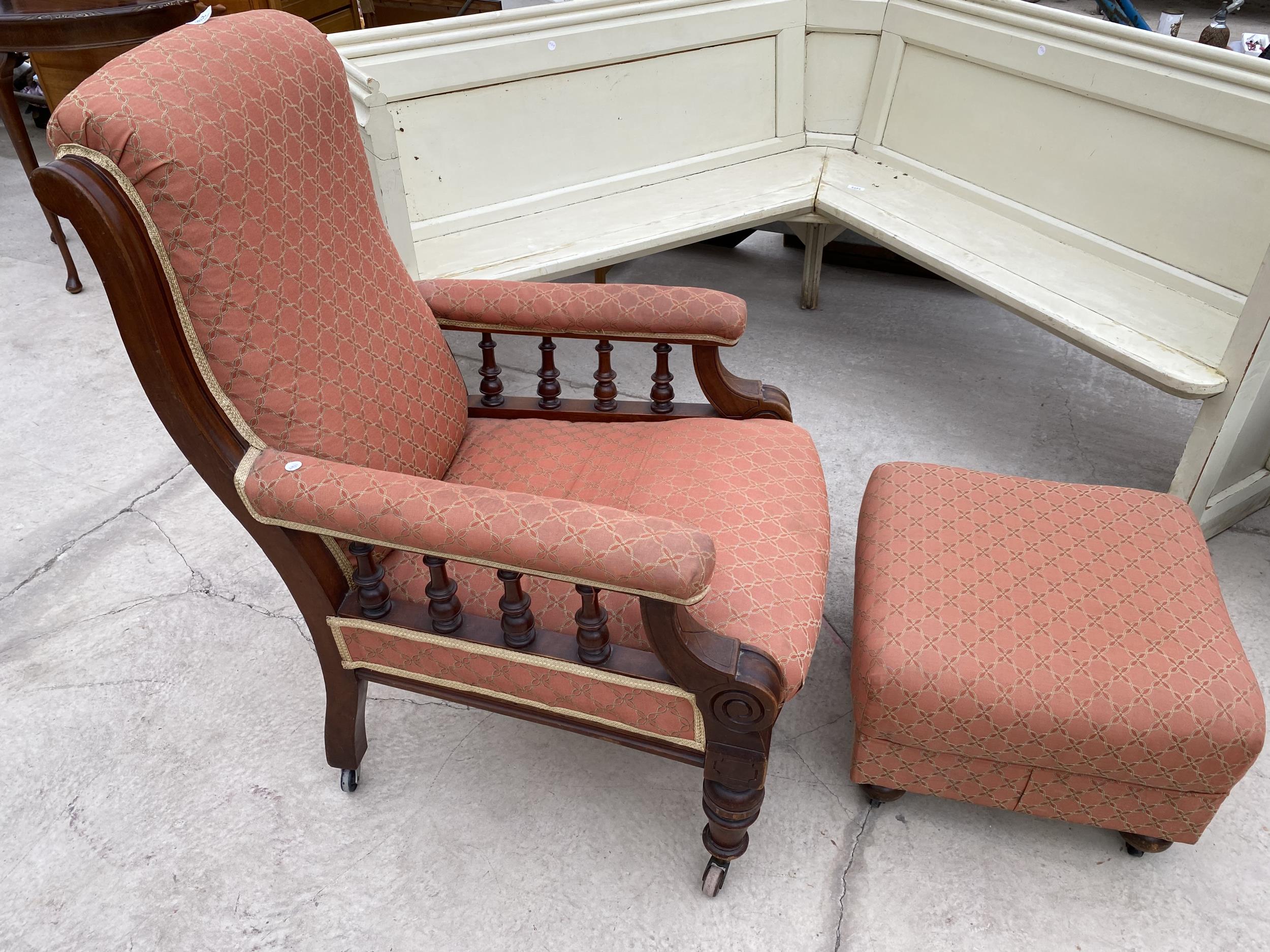 A VICTORIAN MAHOGANY FIRESIDE CHAIR WITH TURNED UPRIGHTS AND FRONT LEGS WITH LATER STOOL HAVING