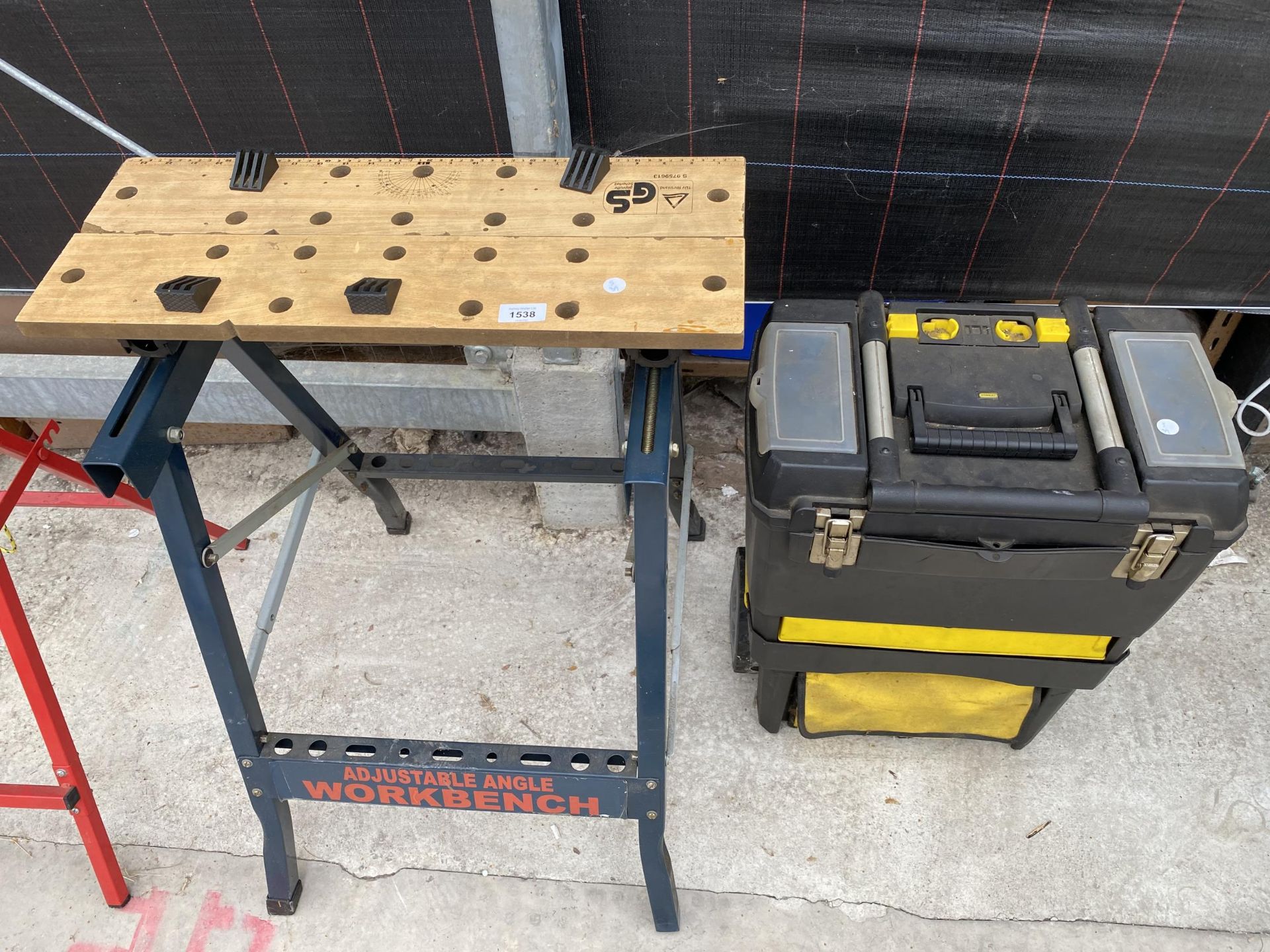 AN ADJUSTABLE WORK BENCH AND A TOOL BOX CONTAINING TOOLS
