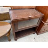 A MID 20TH CENTURY OAK CABINET WITH DROP-DOWN GLASS DOOR ON OPEN BASE, 30" WIDE