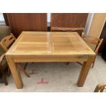 A MODERN OAK EXTENDING DINING TABLE AND A PAIR OF FOLDING CHAIRS