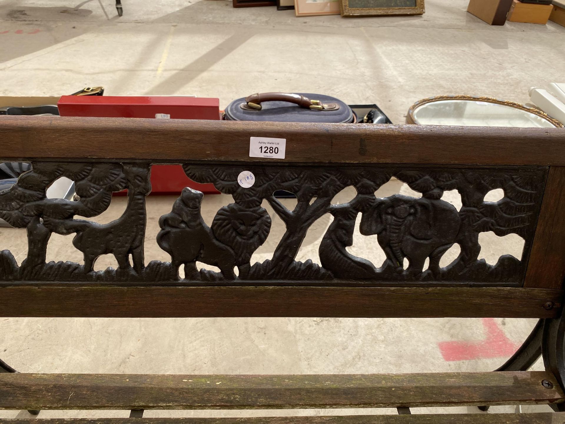 A SMALL CHILDRENS GARDEN BENCH WITH CAST BENCH ENDS AND A CAST BACK DEPICTING A SAFARI SCENE - Image 2 of 3