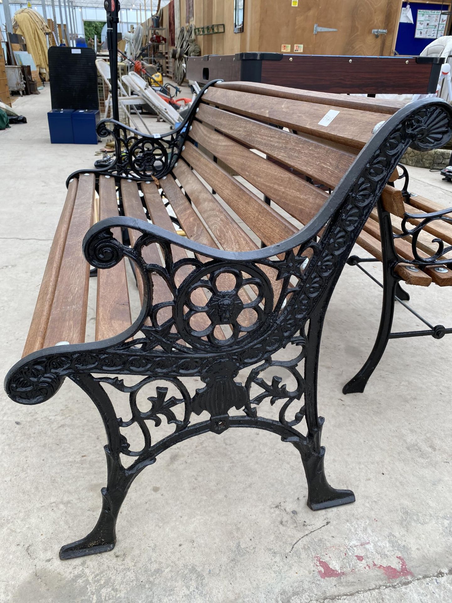 A WOODEN SLATTED GARDEN BENCH WITH CAST BENCH ENDS - Image 3 of 3