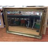 A LARGE ORNATE GILT FRAMED MIRROR 106CM X 76CM