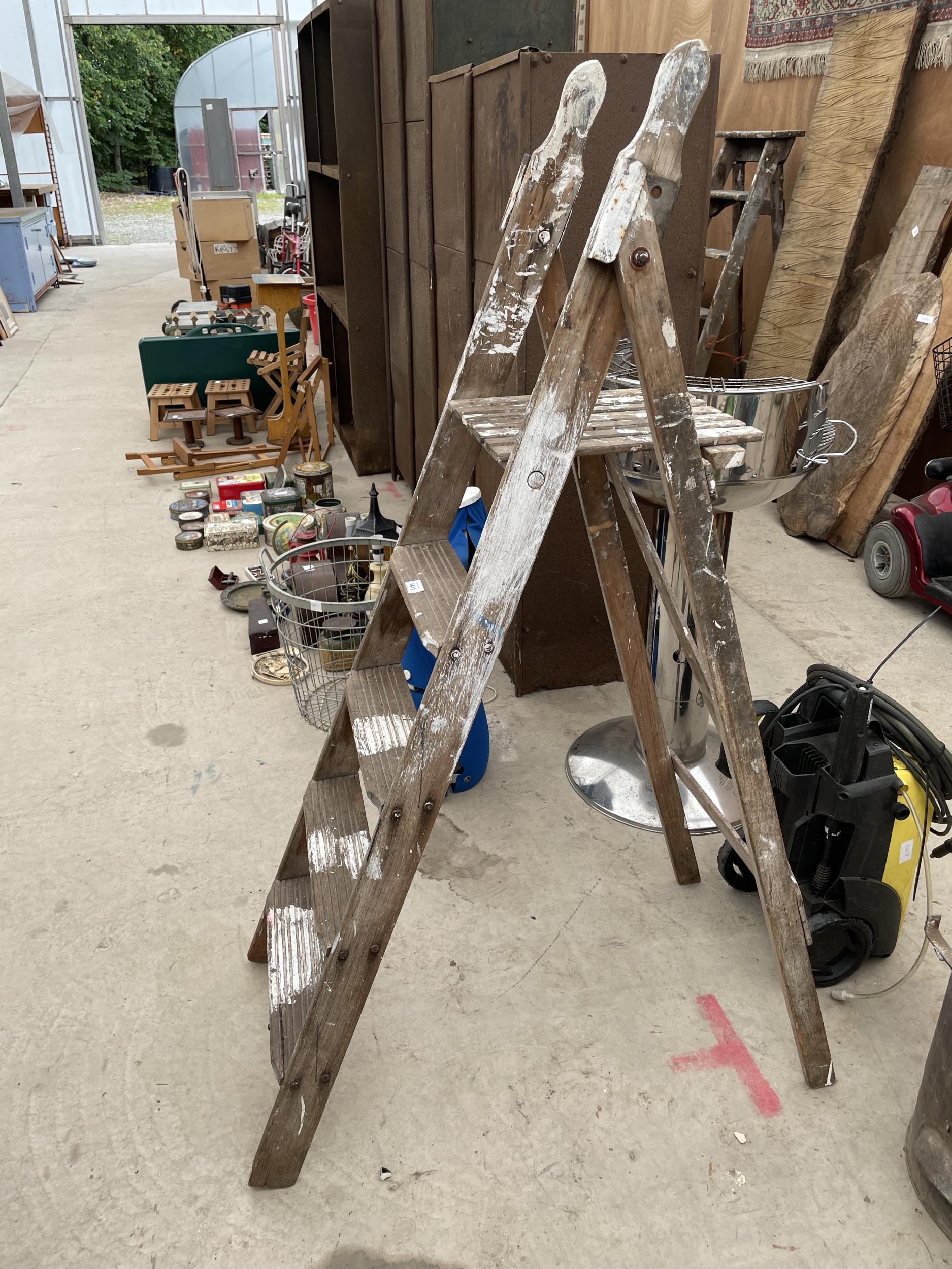 A VINTAGE FOUR RUNG WOODEN STEP LADDER