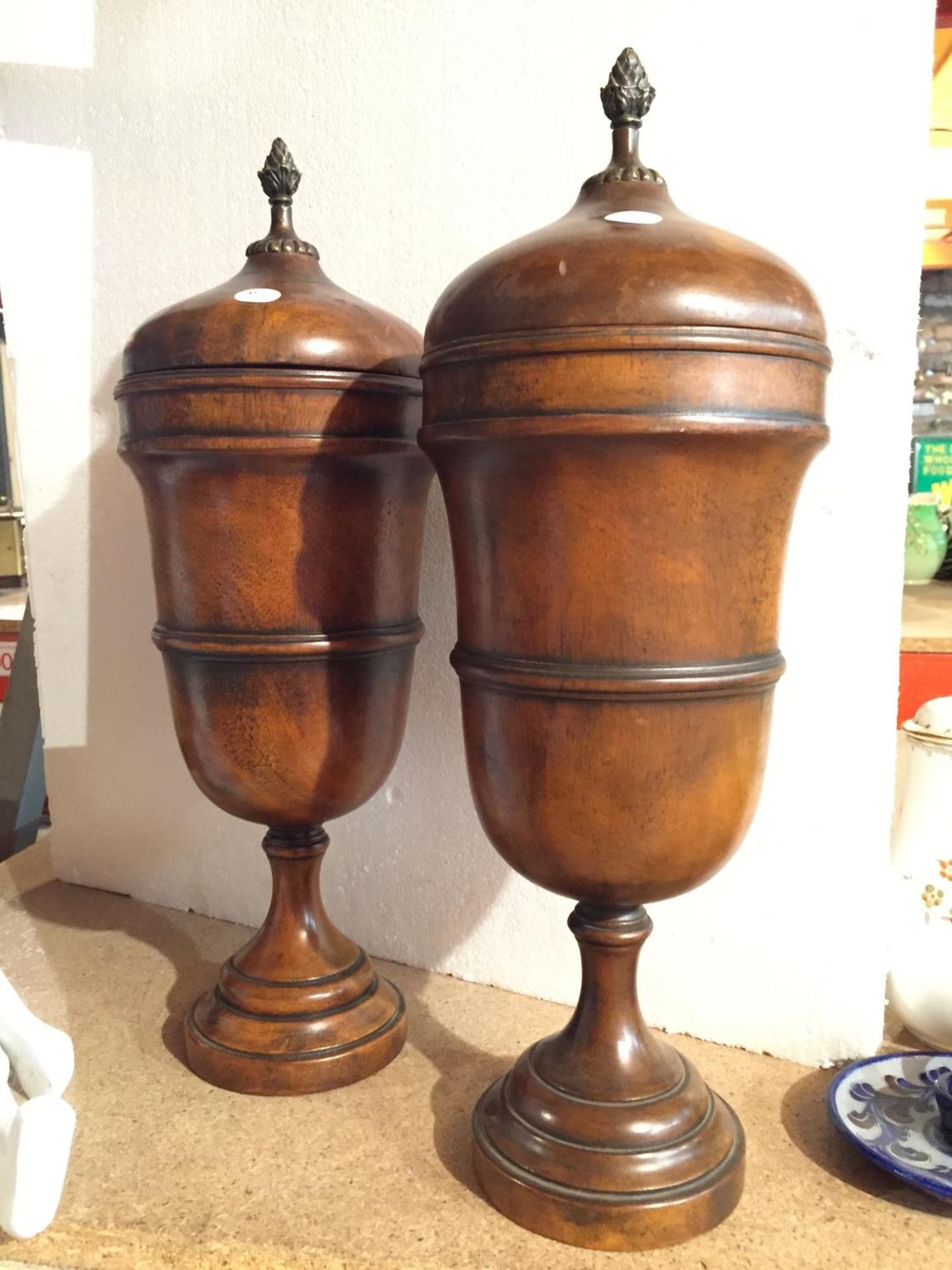 A PAIR OF WOODEN TURNED URNS