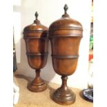 A PAIR OF WOODEN TURNED URNS