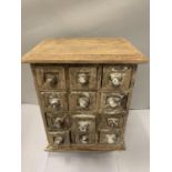 A TWELVE DRAWER MINATURE SHABBY CHIC WOODEN CHEST OF DRAWERS (A/F) 31 X 21 X 17CM