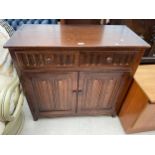 AN OAK OLD CHARM STYLE DRESSER BASE WITH LINEN FOLD DOORS 37.5" WIDE