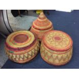 A SET OF THREE LARGE COLOURFUL WOVEN TRIBAL BASKETS WITH LIDS DIAMETER 40CM APPROX