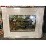 A FRAMED PICTURE OF A BLACK AND WHITE HOUSE