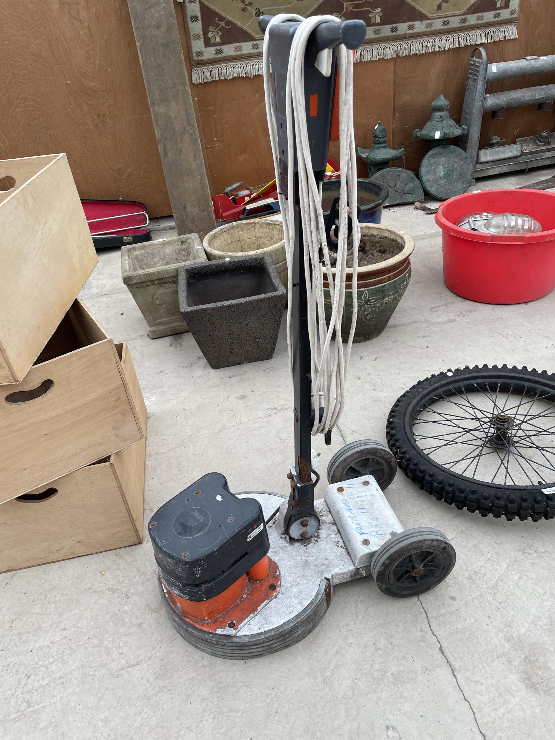 AN ELECTRIC FLOOR POLISHER