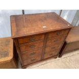 A WALNUT AND CROSSBANDED TV CABINET IN THE FORM OF A CHEST OF DRAWERS 31" WIDE