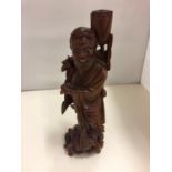 A C.1900 CHINESE ORIENTAL CARVED ROOTWOOD FIGURE OF A MAN, WITH BONE EYES AND TEETH H:36CM