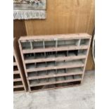 A SMALL 27 SECTION PIGEON HOLE STORAGE UNIT