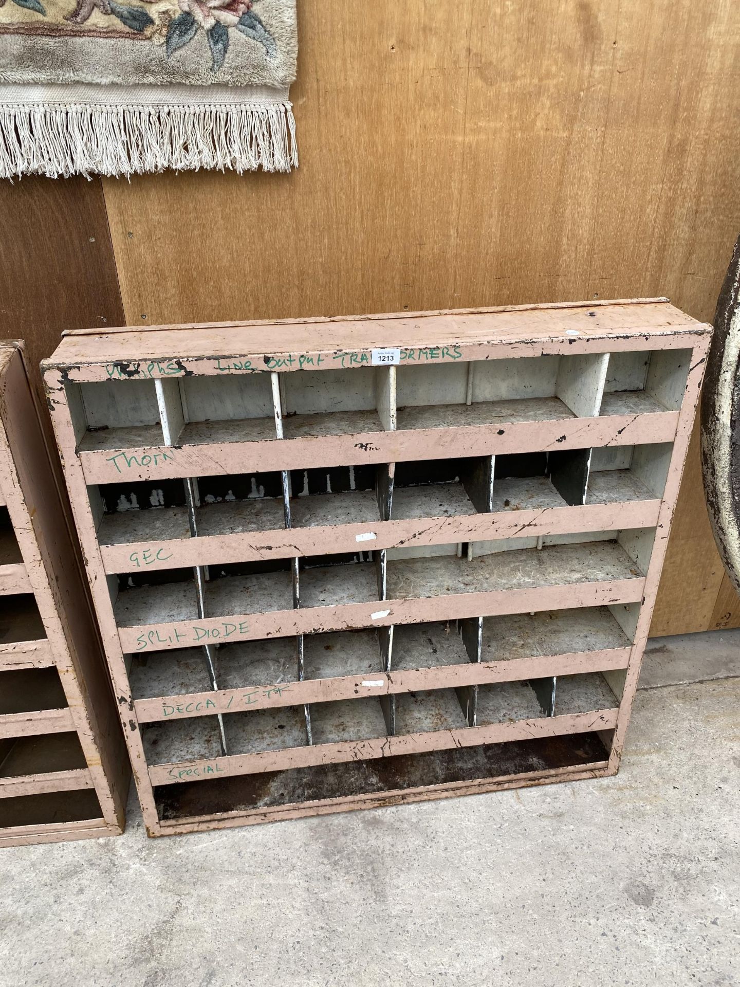 A SMALL 27 SECTION PIGEON HOLE STORAGE UNIT