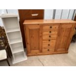 A MODERN PINE CABINET/WARDROBE WITH SIX CENTRAL DRAWERS 62" WIDE AND OPEN PAINTED SHELVES 14.5" WIDE