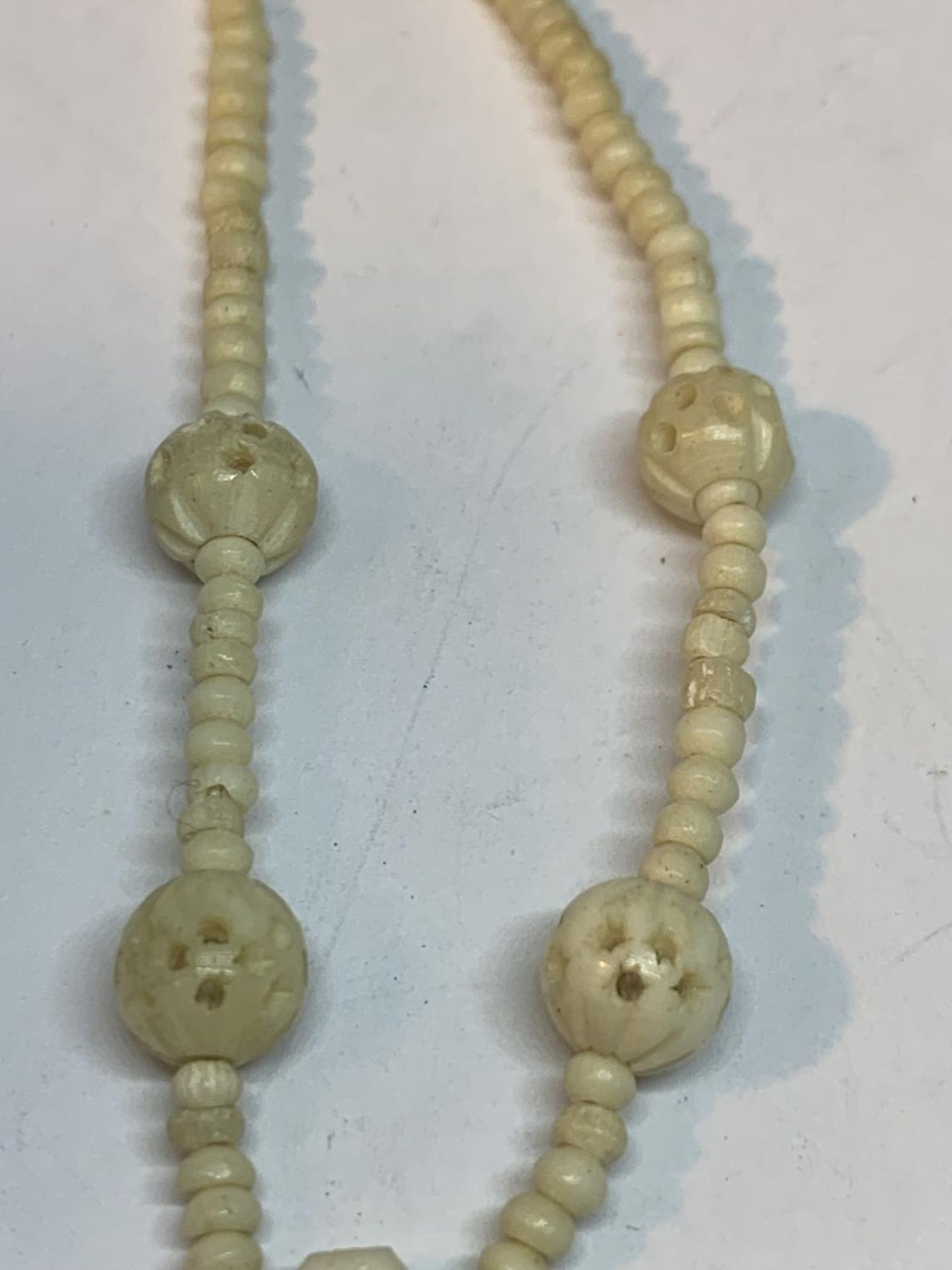 TWO CARVED BONE NECKLACES ONE WITH LARGE FOB AND ONE WITH A CROSS DESIGN - Image 3 of 7
