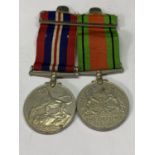 TWO WWII MEDALS WITH RIBBONS TO INCLUDE A DEFENCE MEDAL