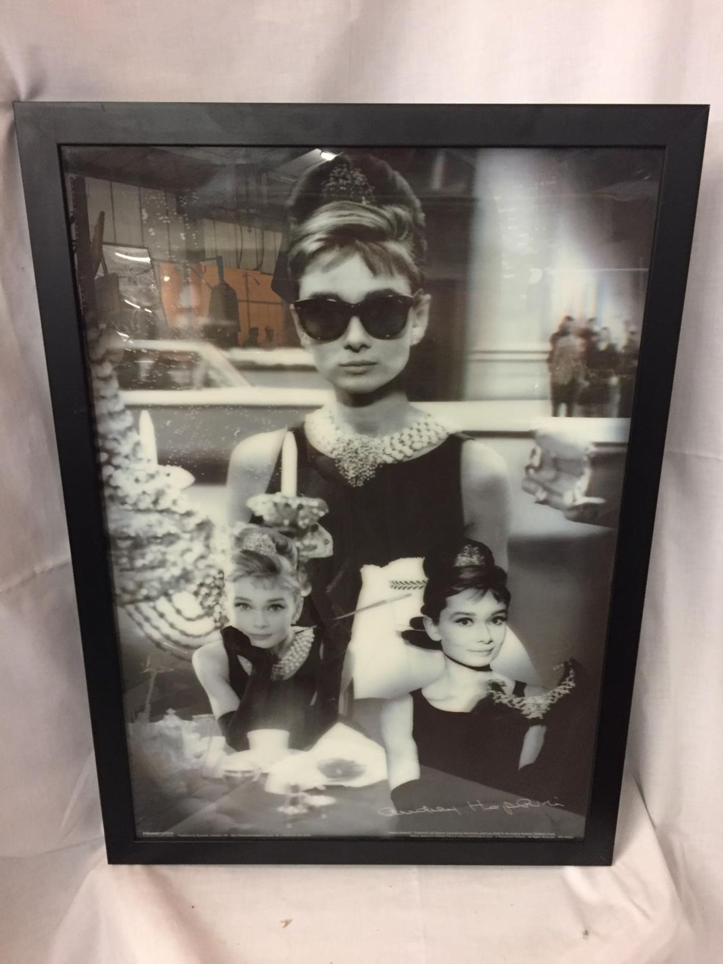 A FRAMED BLACK AND WHITE PICTURE OF AUDREY HEPBURN