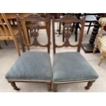A PAIR OF EDWARDIAN LOW NURSING CHAIRS