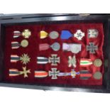 A GLAZED DISPLAY CASE CONTAINING SIXTEEN NAZI GERMANY MEDALS TO INCLUDE MOTHERS BADGE, IRON CROSS,