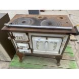 A CAST IRON AND ENAMEL RANGE COOKER