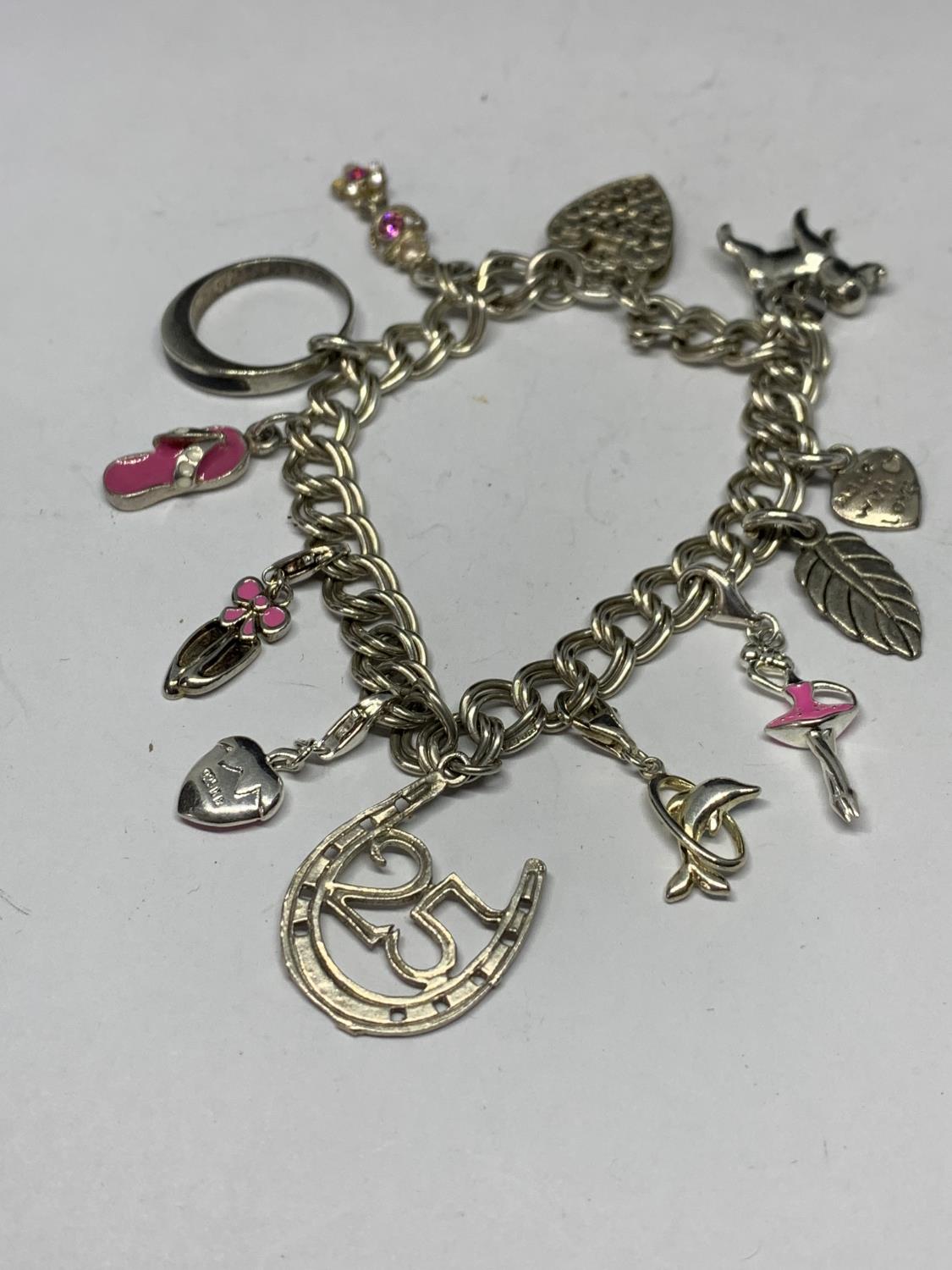 A SILVER CHARM BRACELET WITH ELEVEN CHARMS TO INCLUDE A BALLERINA, BALLET SHOES, DOG ETC