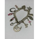 A SILVER CHARM BRACELET WITH ELEVEN CHARMS TO INCLUDE A BALLERINA, BALLET SHOES, DOG ETC