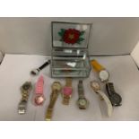 A DECORATIVE GLASS JEWELLERY BOX CONTAINING SEVERAL FASHION WATCHES