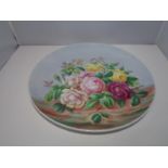 A LARGE FLORAL WALL CHARGER SIGNED T. SIMPSON