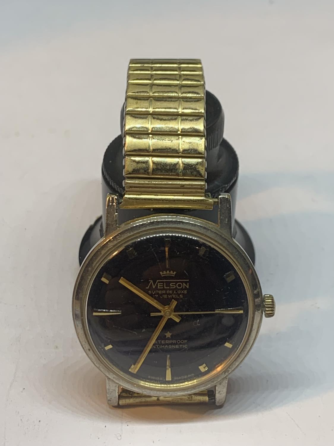 A YELLOW METAL NELSON WRISTWATCH SEEN WORKING BUT NO WARRANTY