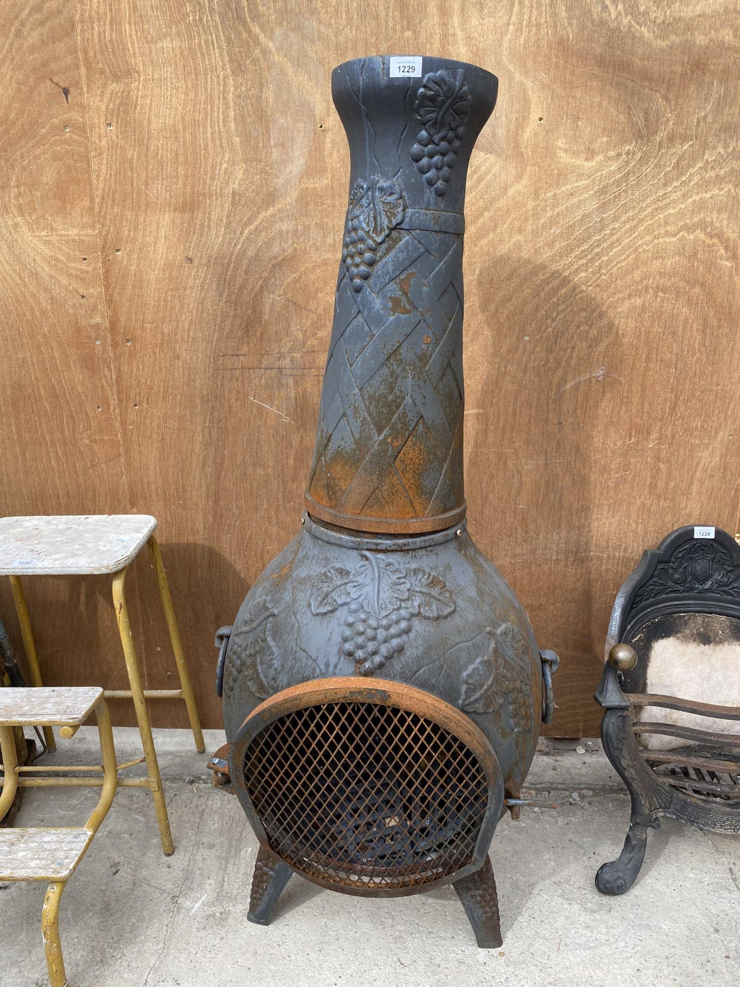 A DECORATIVE CAST IRON GARDEN CHIMENEA