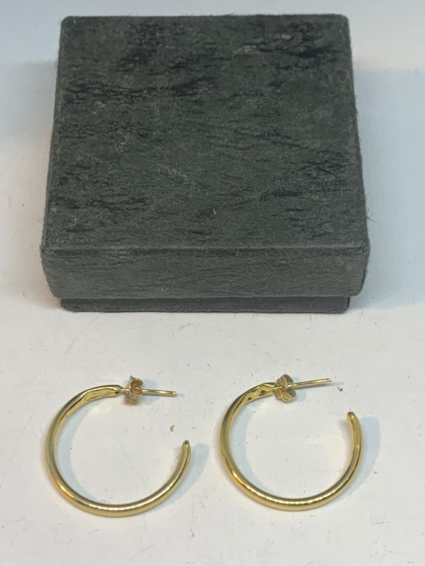 A PAIR OF LARGE 9 CARAT GOLD HOOP EARRINGS IN A PRESENTATION BOX