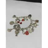 A HEAVY SILVER CHARM BRACELET WITH THIRTEEN CHARMS TO INCLUDE A STRAWBERRY, CHERRIES, DOVE ETC