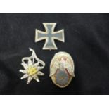 A GERMAN IRON CROSS FIRST CLASS DATED 2008, INFANTRY EDELWEISS BADGE AND A NAZI BADGE (3)