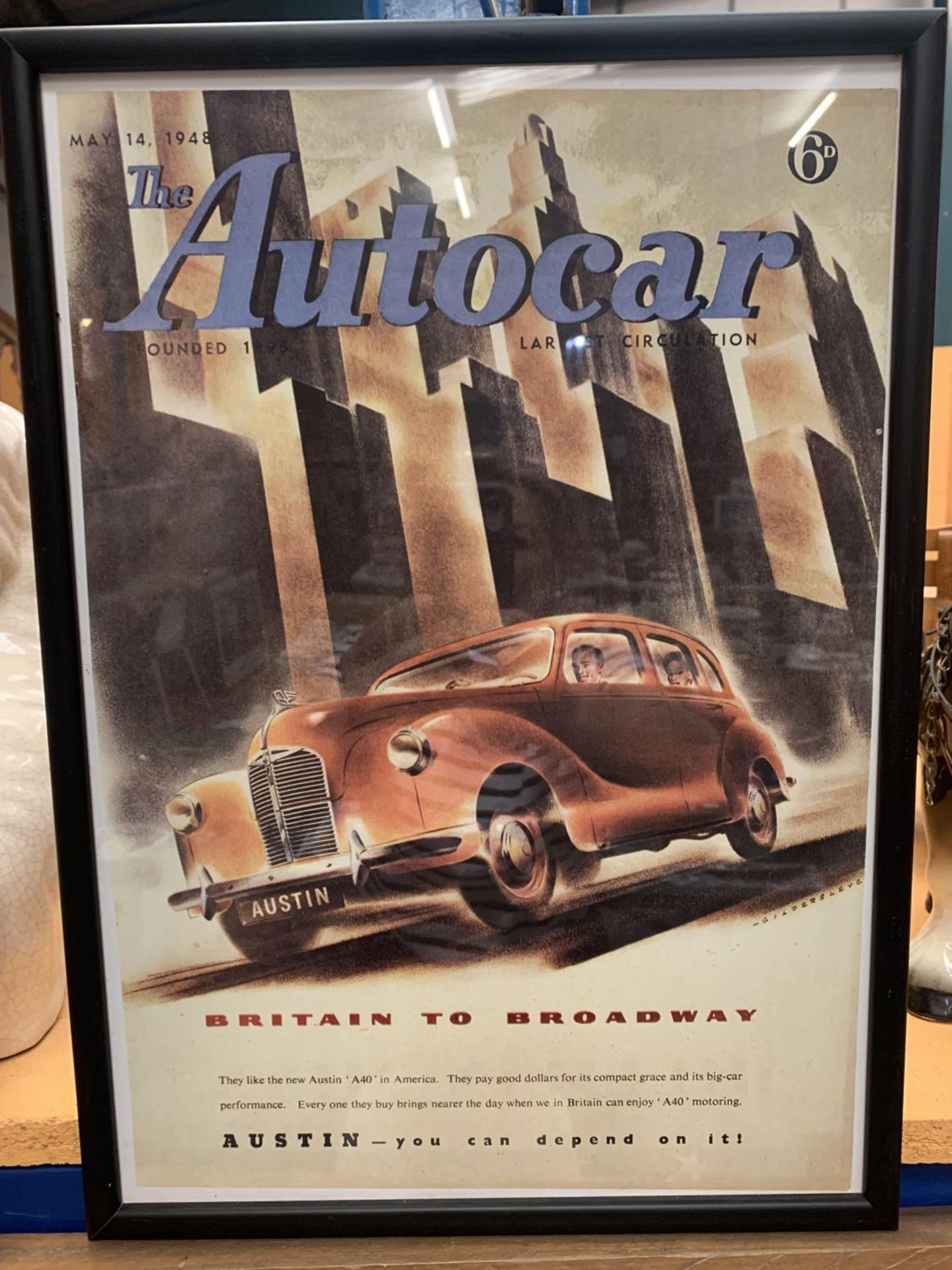 A FRAMED 'THE AUTOCAR' AUSTIN BRITAIN TO BROADWAY POSTER MAY 14TH 1948 44CM X 31.5CM