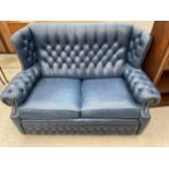 A BLUE COLLINGWOOD BED SETTEE IN THE CHESTERFIELD STYLE