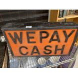 AN ILLUMINATED 'WE PAY CASH' SIGN
