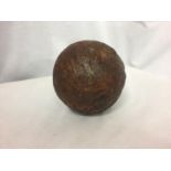 A CAST IRON CANNONBALL RECOVERED FROM THE WRECK OF H.M.S. ASSOCIATION. THE SHIP SANK IN 1707 WITH